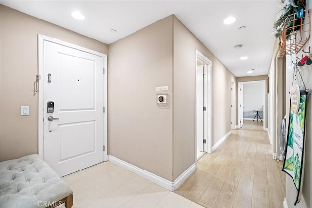 foyer entrance with light hardwood / wood-style floors