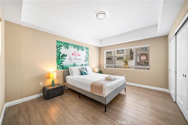 bedroom with a closet and light hardwood / wood-style flooring