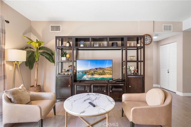 living area with hardwood / wood-style floors