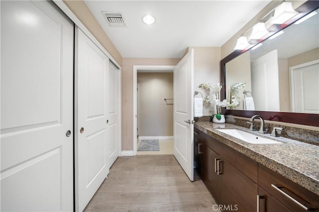 bathroom with vanity and hardwood / wood-style flooring