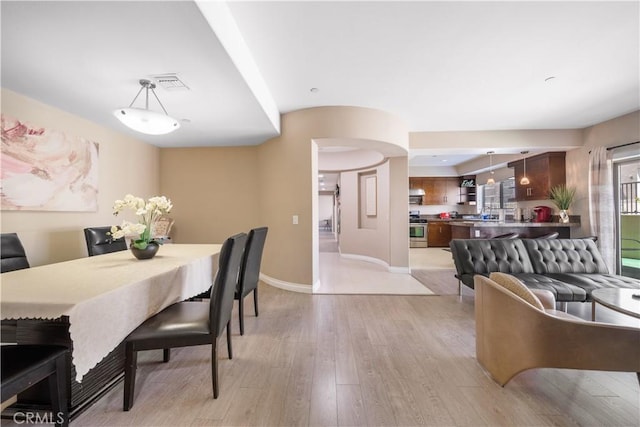 dining area featuring light wood-type flooring