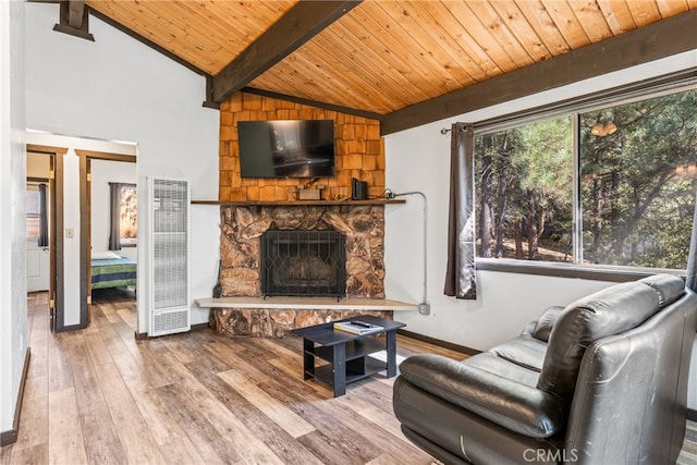 living room with wooden ceiling, vaulted ceiling with beams, a stone fireplace, and hardwood / wood-style flooring