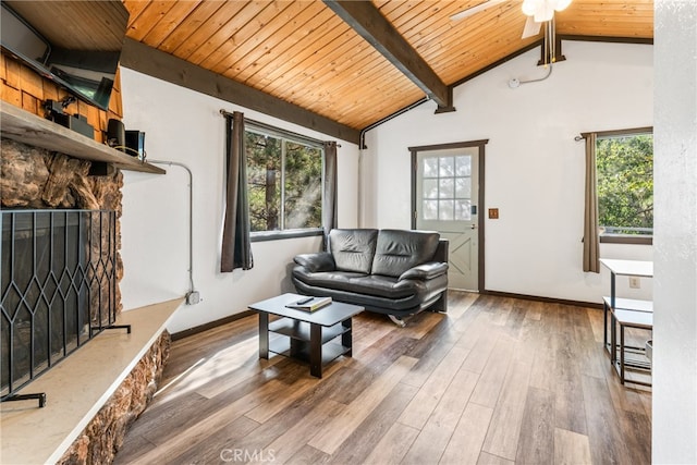 sitting room featuring lofted ceiling with beams, wood-type flooring, ceiling fan, and a fireplace