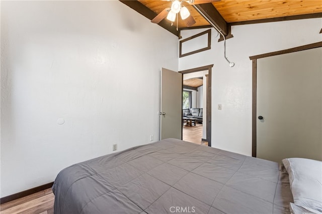 bedroom with wooden ceiling, vaulted ceiling with beams, ceiling fan, and light hardwood / wood-style flooring