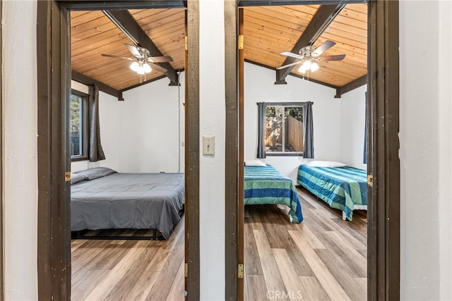 bedroom featuring ceiling fan, lofted ceiling with beams, hardwood / wood-style floors, and wooden ceiling