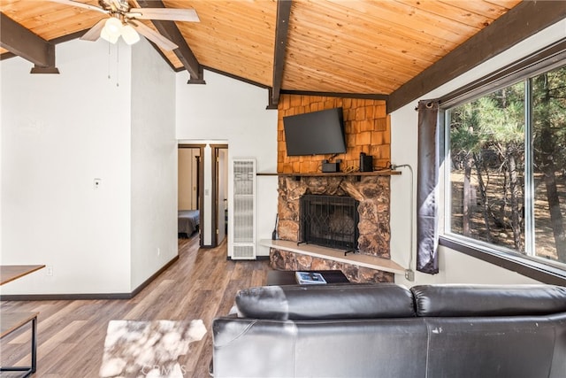 living room featuring ceiling fan, vaulted ceiling with beams, wooden ceiling, a fireplace, and hardwood / wood-style floors