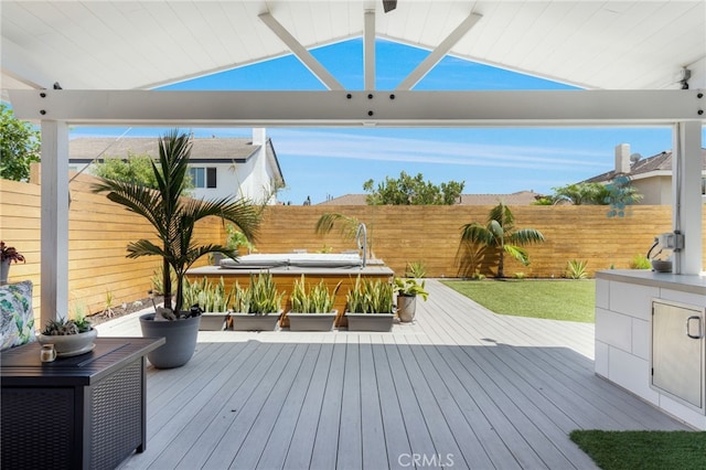 wooden deck featuring a hot tub