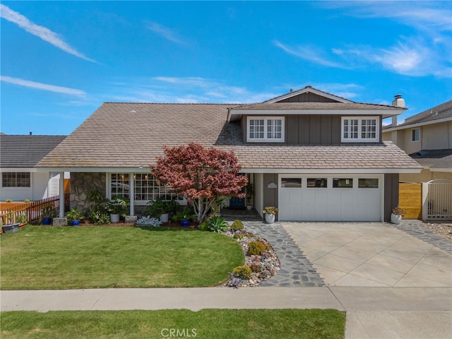 view of property with a garage and a front lawn