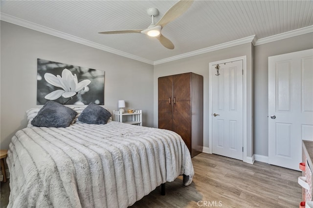 bedroom featuring ceiling fan, hardwood / wood-style floors, and ornamental molding