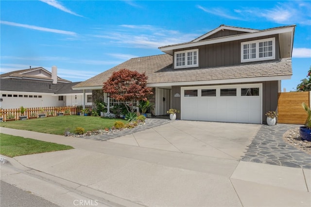 front facade featuring a garage and a front yard