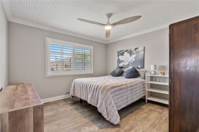 bedroom featuring ceiling fan, light wood-type flooring, and crown molding