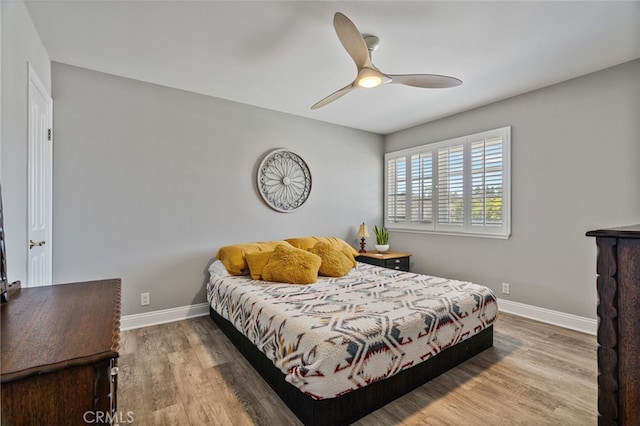 bedroom featuring hardwood / wood-style floors and ceiling fan