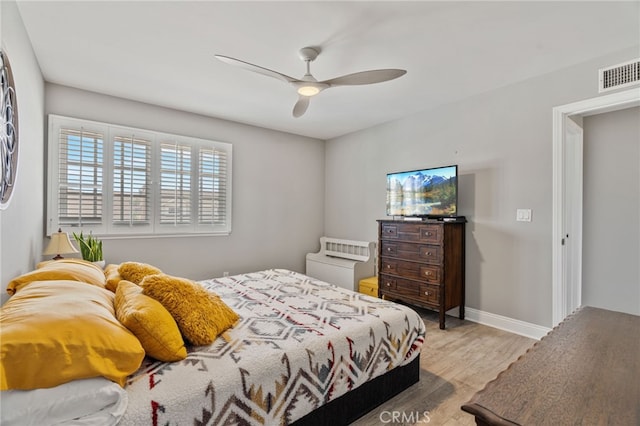 bedroom with ceiling fan and light hardwood / wood-style floors