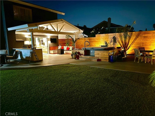 view of yard with a deck and exterior kitchen