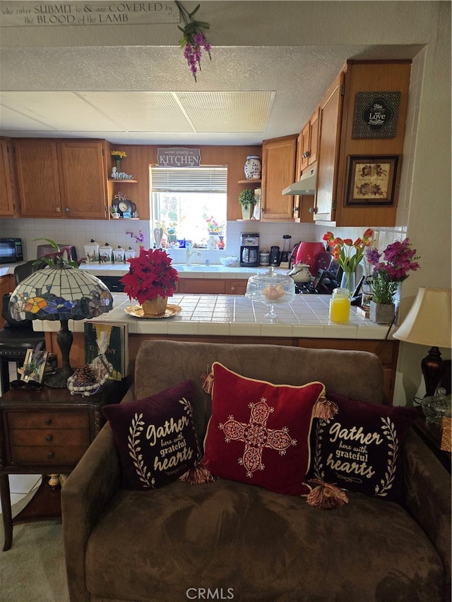 kitchen with decorative backsplash and tile countertops