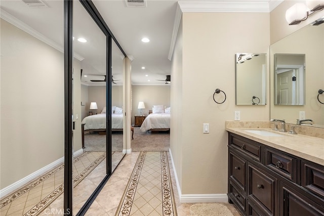 bathroom with crown molding, vanity, and ceiling fan