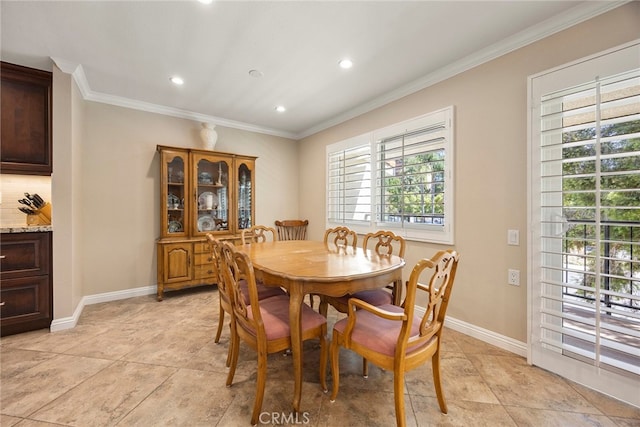 tiled dining space featuring crown molding