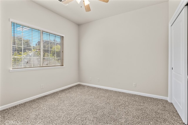 interior space featuring ceiling fan and carpet flooring