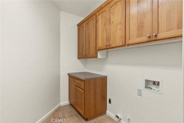 laundry area featuring cabinets, electric dryer hookup, light tile patterned floors, hookup for a washing machine, and gas dryer hookup