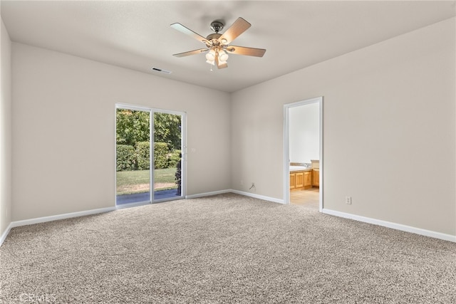 empty room with ceiling fan and light colored carpet