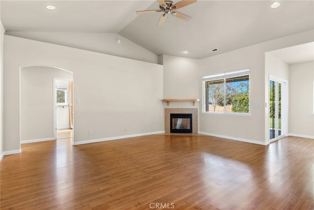 unfurnished living room featuring lofted ceiling, hardwood / wood-style floors, and ceiling fan