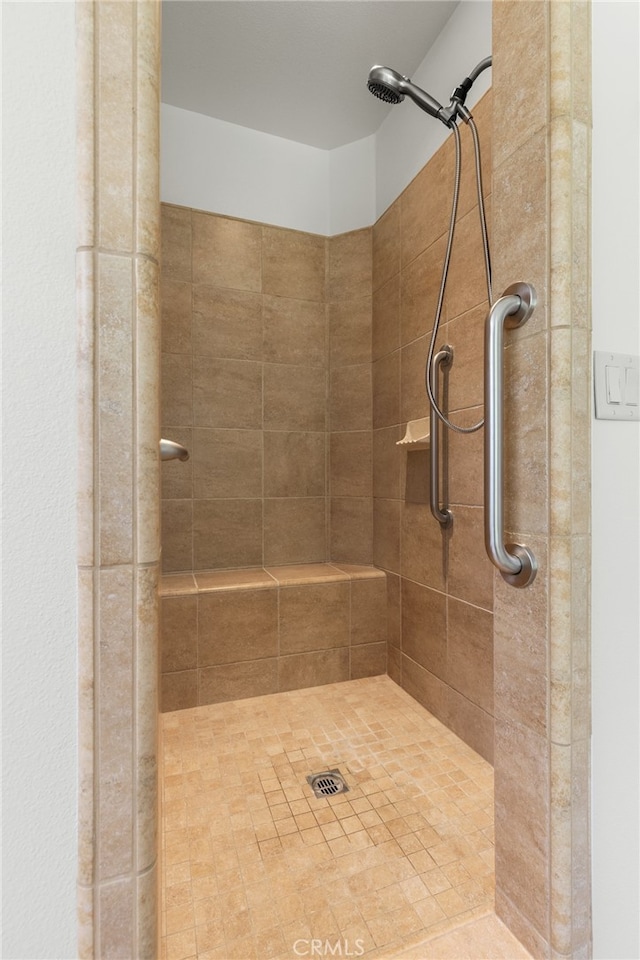 bathroom with tiled shower