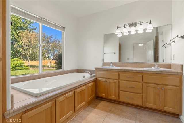 bathroom featuring a bath, tile patterned flooring, vanity, and a wealth of natural light