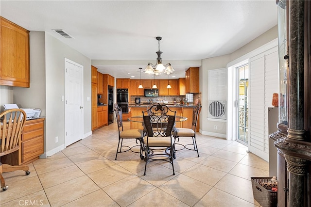 tiled dining area with a chandelier