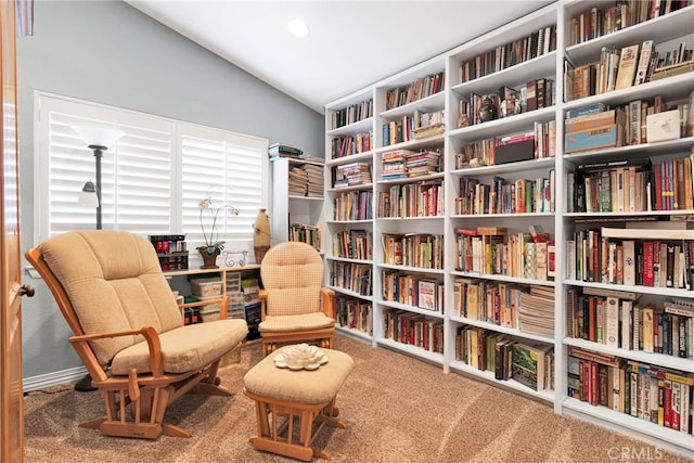 living area featuring vaulted ceiling and carpet floors