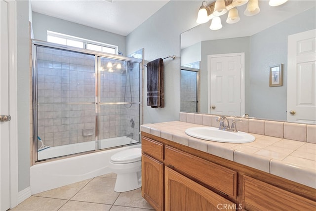 full bathroom featuring tile patterned flooring, toilet, vanity, and enclosed tub / shower combo