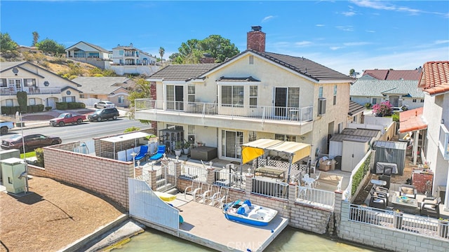 back of house with a balcony and a patio