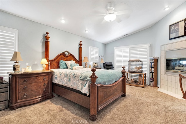 bedroom featuring ceiling fan, vaulted ceiling, and light colored carpet