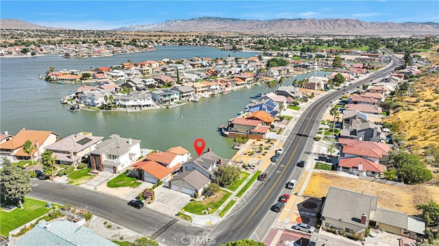 aerial view featuring a water and mountain view