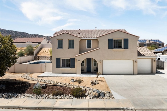 mediterranean / spanish-style house with a garage