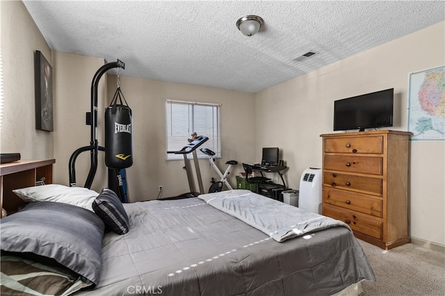 bedroom with light carpet and a textured ceiling