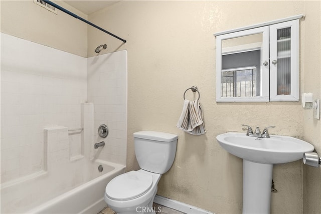 full bathroom featuring toilet, bathing tub / shower combination, and sink