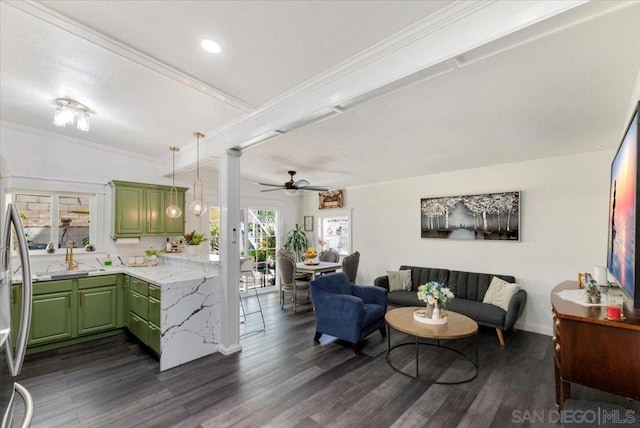 living room featuring crown molding, ornate columns, sink, dark wood-type flooring, and ceiling fan