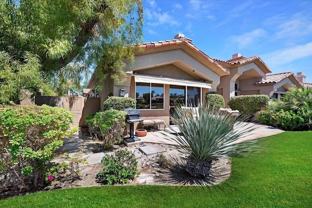 rear view of property with a lawn