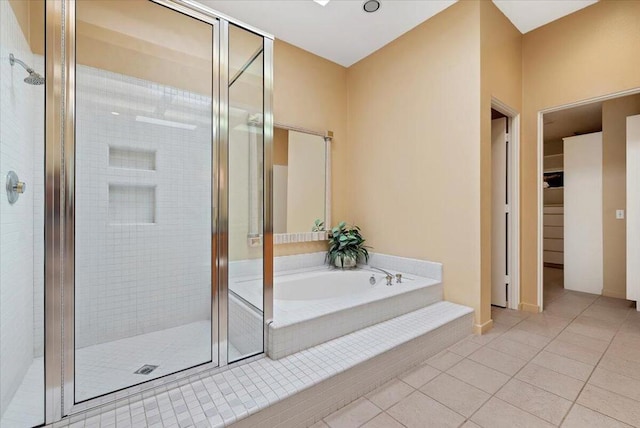 bathroom featuring plus walk in shower and tile patterned flooring