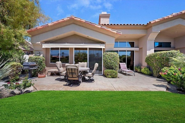 back of house featuring a patio and a lawn