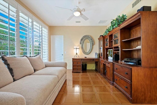 tiled living room with ceiling fan