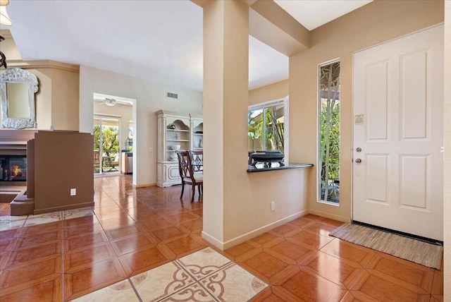 tiled entryway featuring ceiling fan