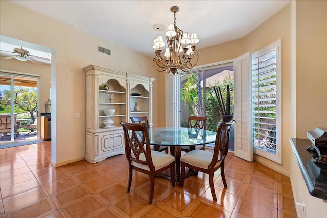 tiled dining space with ceiling fan with notable chandelier