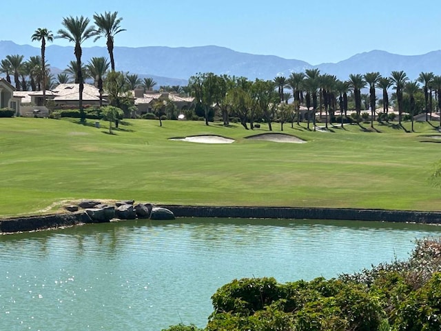 surrounding community featuring a water and mountain view and a yard