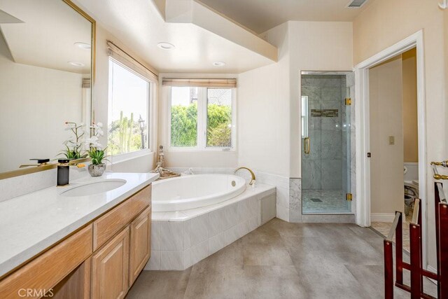 bathroom featuring vanity, separate shower and tub, and tile patterned flooring