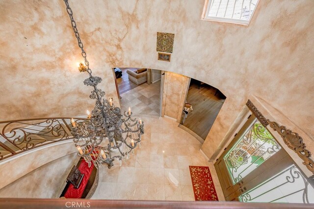 interior space featuring a high ceiling and tile patterned flooring