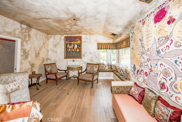 living room with lofted ceiling and wood-type flooring