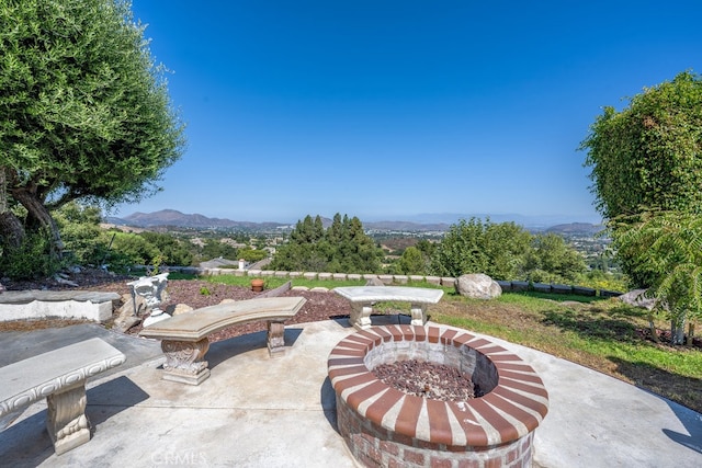 view of patio featuring a mountain view and an outdoor fire pit