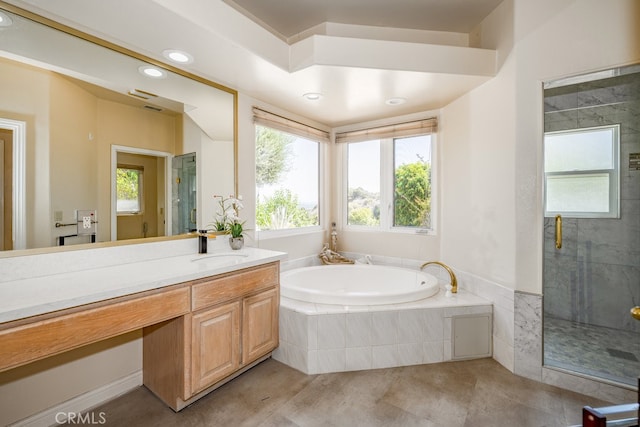 bathroom featuring plus walk in shower, tile patterned flooring, and vanity