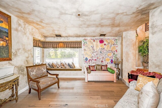 living area with hardwood / wood-style flooring